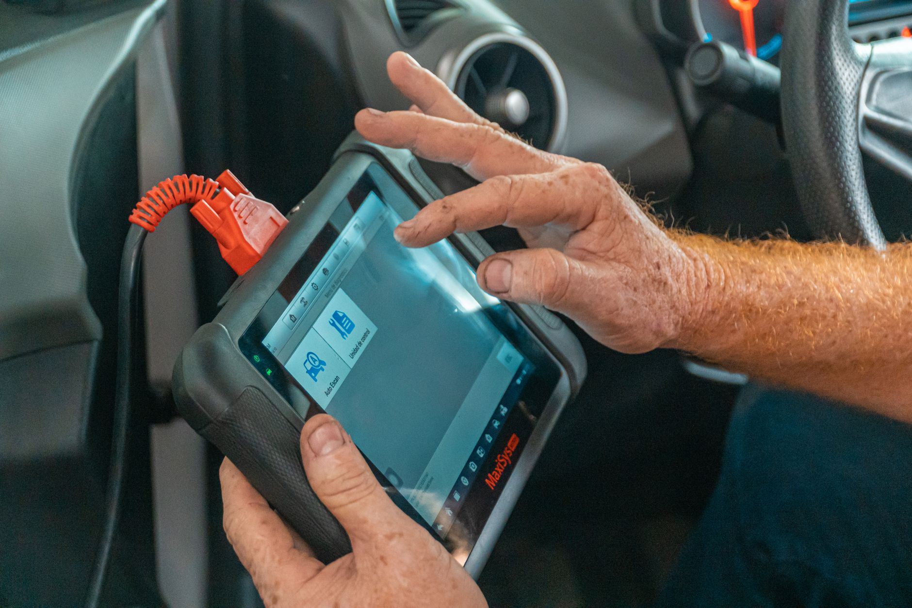 person holding blue diagnostic tool