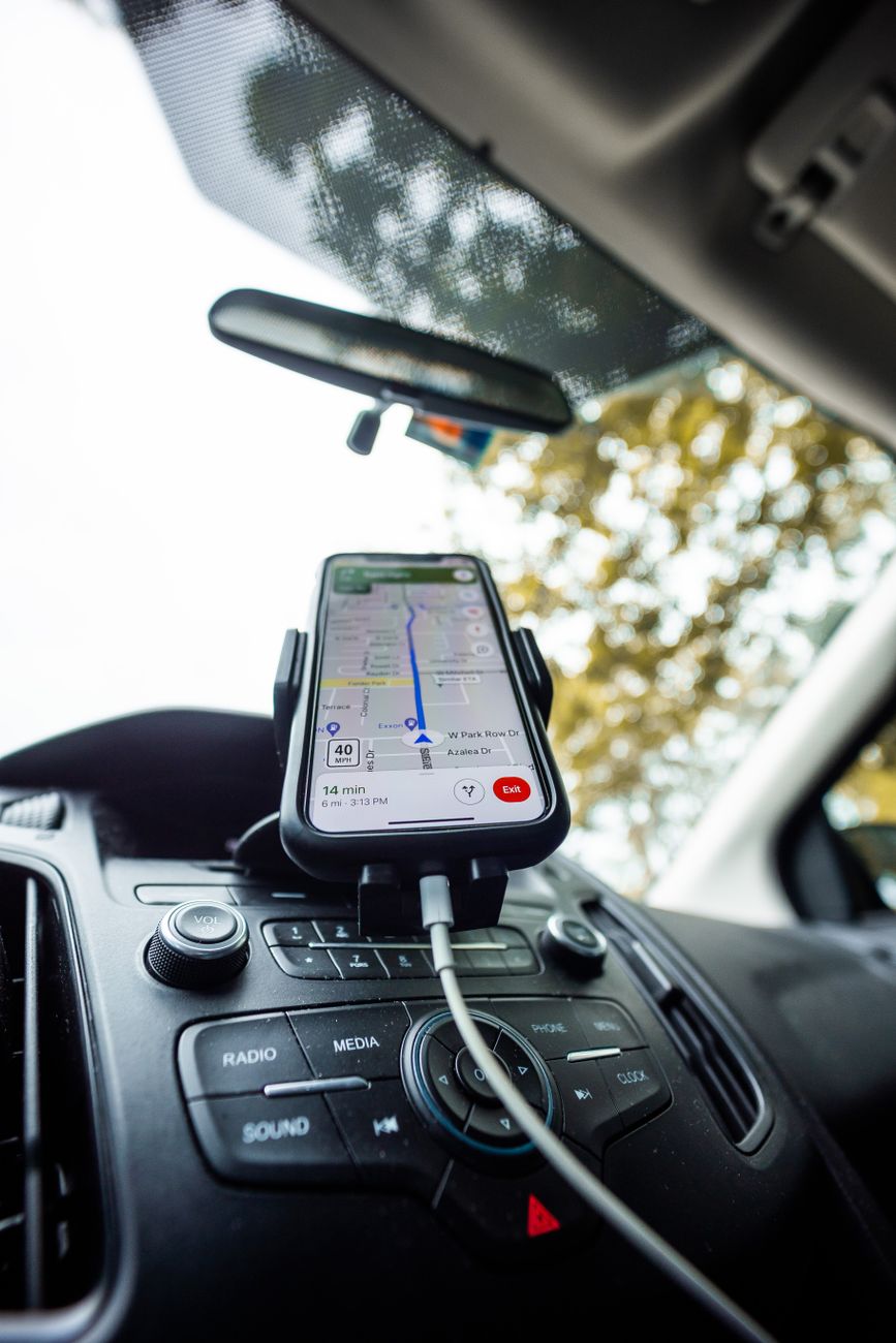 mobile phone with white cable charger on phone holder