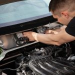 man fixing a car