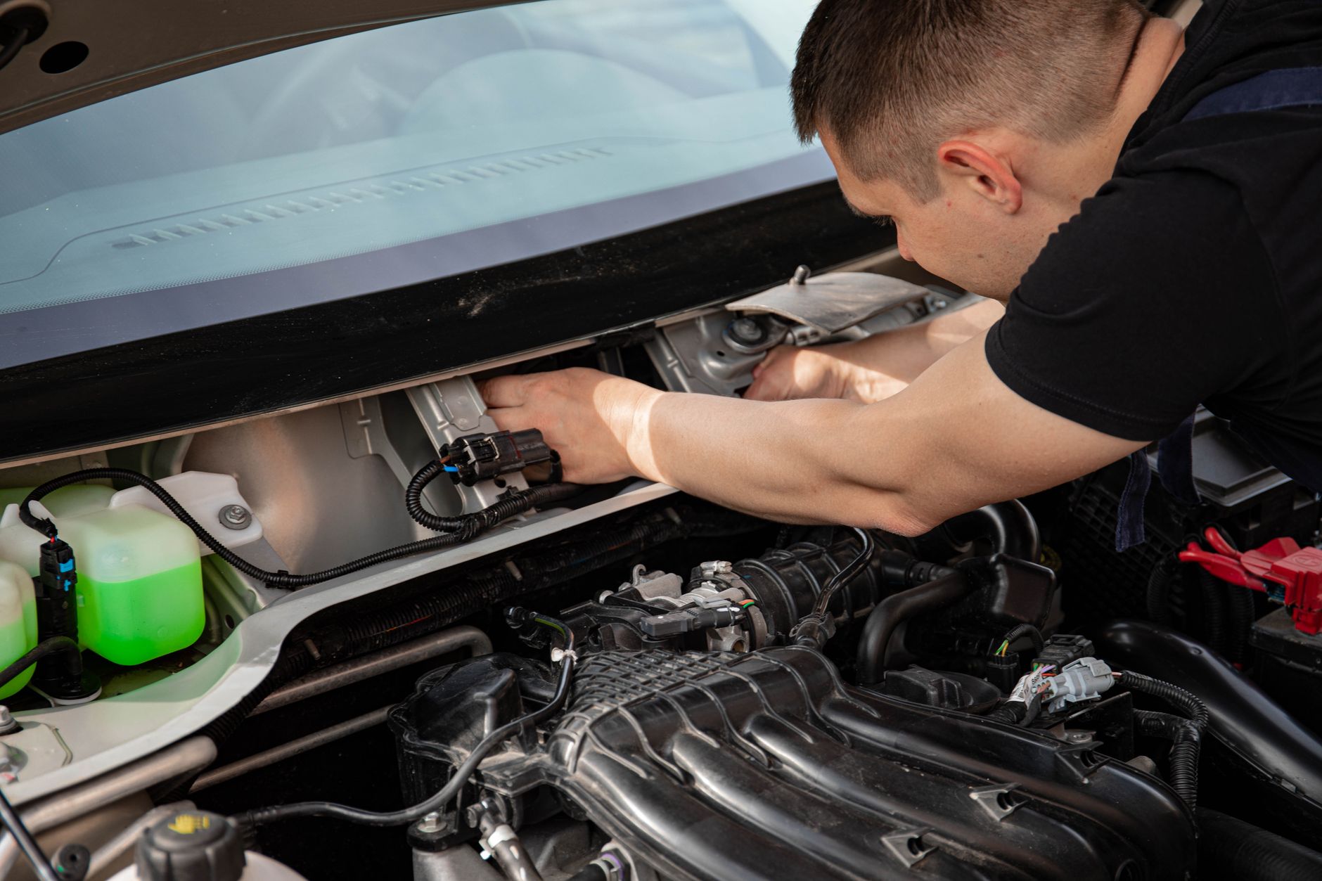 man fixing a car