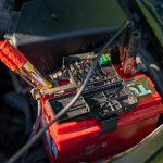 car battery with jumper cables in engine bay