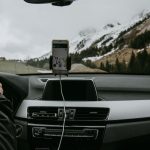 snowy mountains through windshield of car